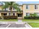 Inviting exterior view of a two-story townhouse with a well-maintained lawn and mature landscaping at 10807 Keys Gate Dr, Riverview, FL 33579