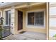 A welcoming front porch features a brown entry door, large window, and AC unit at 10807 Keys Gate Dr, Riverview, FL 33579