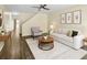 Bright living room showcasing neutral decor, hardwood floors, a ceiling fan, and art at 10807 Keys Gate Dr, Riverview, FL 33579