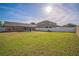 Expansive backyard with lush grass, fenced perimeter, and screened porch at 10841 Standing Stone Dr, Wimauma, FL 33598