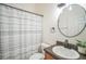 Bathroom features a single sink vanity, toilet, and shower with curtain at 10841 Standing Stone Dr, Wimauma, FL 33598