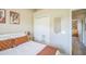 Bright bedroom featuring a closet, accent wall hanging, and neutral color palette at 10841 Standing Stone Dr, Wimauma, FL 33598
