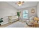 Bedroom boasts a crib, chair, accent rug, and large window providing great light at 10841 Standing Stone Dr, Wimauma, FL 33598