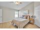 Comfortable bedroom with light walls, wood-look floors, and ample natural light at 10841 Standing Stone Dr, Wimauma, FL 33598