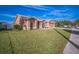 Inviting single-story home with lush green lawn, covered entryway, and attached two-car garage at 10841 Standing Stone Dr, Wimauma, FL 33598