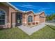 Close up of house entrance highlighting the well-kept landscaping and charming architectural details at 10841 Standing Stone Dr, Wimauma, FL 33598