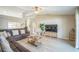 Cozy living room with a comfortable sectional sofa, light wood floors, and plenty of natural light at 10841 Standing Stone Dr, Wimauma, FL 33598
