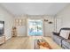 Bright living room featuring light wood floors, neutral walls, and sliding glass doors to the patio at 10841 Standing Stone Dr, Wimauma, FL 33598