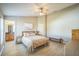 Bright main bedroom with light walls, ceiling fan, and an ensuite bathroom at 10841 Standing Stone Dr, Wimauma, FL 33598