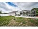 Landscaped backyard with a screened-in pool area and privacy fence at 11209 Kangley Ln, Spring Hill, FL 34608