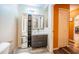 Bright bathroom featuring a modern vanity with storage, a large mirror, and a shower at 11209 Kangley Ln, Spring Hill, FL 34608