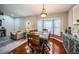 Inviting dining room with a rustic wood table, bay window and decorative lighting at 11209 Kangley Ln, Spring Hill, FL 34608