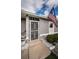 Close-up of the home's entrance, featuring a decorative security door and charming American flag at 11209 Kangley Ln, Spring Hill, FL 34608