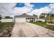 Well-maintained single-Gathering home with a spacious driveway and manicured lawn, under a bright blue sky with scattered clouds at 11209 Kangley Ln, Spring Hill, FL 34608
