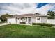 Inviting home exterior with a lush green lawn, showcasing its curb appeal and serene neighborhood setting at 11209 Kangley Ln, Spring Hill, FL 34608
