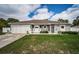 Charming single-story home with well-manicured lawn and welcoming entrance and a two car garage at 11209 Kangley Ln, Spring Hill, FL 34608