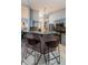 Kitchen island with seating, stainless steel appliances, and neutral countertops at 11209 Kangley Ln, Spring Hill, FL 34608