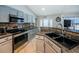 Modern kitchen featuring sleek gray cabinets, granite countertops, and stainless steel appliances at 11209 Kangley Ln, Spring Hill, FL 34608