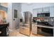 Modern kitchen with stainless steel refrigerator and adjacent dining area at 11209 Kangley Ln, Spring Hill, FL 34608
