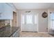View of kitchen featuring tiled flooring, granite countertops, and door leading to outside at 11209 Kangley Ln, Spring Hill, FL 34608