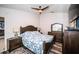 Cozy main bedroom featuring a ceiling fan, comfortable bed, and wooden furniture at 11209 Kangley Ln, Spring Hill, FL 34608