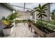 This covered lanai features charming potted plants, offering a serene outdoor space at 11209 Kangley Ln, Spring Hill, FL 34608