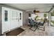 Cozy screened-in patio offers an outdoor dining area, ceiling fan and access to the backyard at 11209 Kangley Ln, Spring Hill, FL 34608