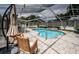 Relaxing view of the screened-in pool area with lounge chairs, perfect for outdoor enjoyment at 11209 Kangley Ln, Spring Hill, FL 34608