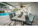 Screened-in patio with outdoor dining, seating area, and pool view, perfect for entertaining at 11209 Kangley Ln, Spring Hill, FL 34608