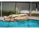 Close-up of pool waterfall, showcasing the rock detail and cascading water feature at 11209 Kangley Ln, Spring Hill, FL 34608