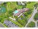 Aerial view of community clubhouse with pool, fountain, parking, and meticulous landscaping at 11250 Hollander Ave, Hudson, FL 34667