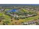 Aerial view showcases the community's lush landscaping, serene lake, and well-maintained golf course at 11250 Hollander Ave, Hudson, FL 34667