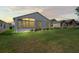 Backyard featuring a well-maintained lawn, fresh landscaping, and the back of the house at 11250 Hollander Ave, Hudson, FL 34667