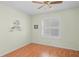Bedroom showcasing laminate wood flooring, a ceiling fan, and a window with white shutters at 11250 Hollander Ave, Hudson, FL 34667