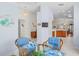 Bright breakfast nook with a glass table, comfortable chairs, and open access to living areas at 11250 Hollander Ave, Hudson, FL 34667