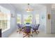 Charming breakfast nook with a glass table, comfortable chairs, and sunlit windows at 11250 Hollander Ave, Hudson, FL 34667