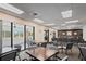 Well-lit clubhouse features tables and chairs, as well as access to a patio with views of the golf course at 11250 Hollander Ave, Hudson, FL 34667