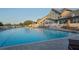 Outdoor community swimming pool with several lounge chairs and umbrellas next to the club house at 11250 Hollander Ave, Hudson, FL 34667