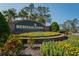 Beautifully landscaped entrance to Heritage Pines, an active 55+ country club living community at 11250 Hollander Ave, Hudson, FL 34667