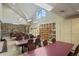 Brightly lit craft room featuring tables, chairs, and storage shelves for creative activities and hobbies at 11250 Hollander Ave, Hudson, FL 34667