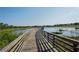 Picturesque wooden dock extends over a serene lake, offering tranquil waterfront views and leisure opportunities at 11250 Hollander Ave, Hudson, FL 34667