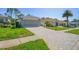 Charming home featuring a meticulously maintained lawn and paved driveway on a sunny day at 11250 Hollander Ave, Hudson, FL 34667