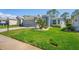 Charming home featuring a meticulously maintained lawn and paved driveway on a sunny day at 11250 Hollander Ave, Hudson, FL 34667