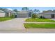 Well-kept single Gathering house with a beautiful lawn and patterned brick driveway on a sunny day at 11250 Hollander Ave, Hudson, FL 34667