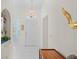 Bright foyer featuring tile flooring, a decorative chandelier, and views into other rooms at 11250 Hollander Ave, Hudson, FL 34667