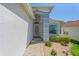 View of the home's front entrance, showing the walkway and landscaping at 11250 Hollander Ave, Hudson, FL 34667