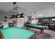 Game room area with pool tables, tables with chairs, and a cozy atmosphere for community enjoyment at 11250 Hollander Ave, Hudson, FL 34667