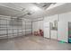 Well-organized garage with storage, refrigerator, and garage door opener at 11250 Hollander Ave, Hudson, FL 34667