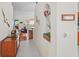 Hallway featuring tile flooring, decorative wall art, and a view into the living room at 11250 Hollander Ave, Hudson, FL 34667