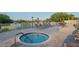 Community hot tub for residents, surrounded by lounge chairs and umbrellas, next to the golf course at 11250 Hollander Ave, Hudson, FL 34667